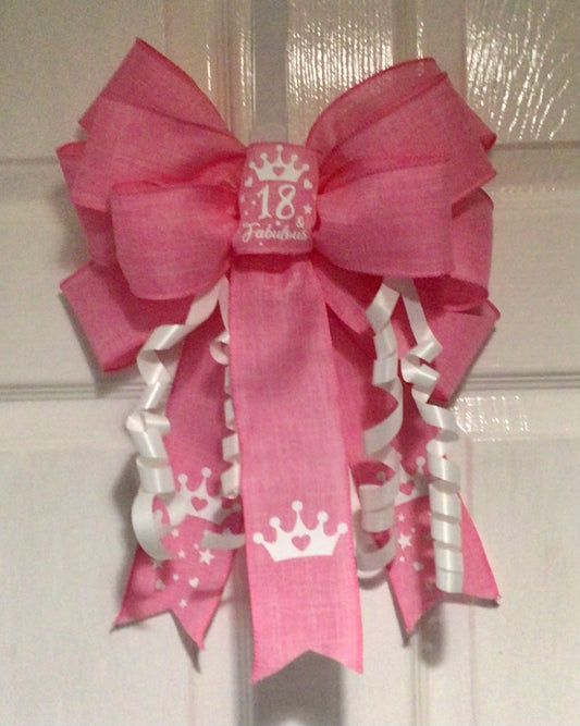 18th birthday bow in candy pink burlap ribbon with the central loop carrying the words '18 & fabulous' in white. Luxury door, wreath or gift bow.
